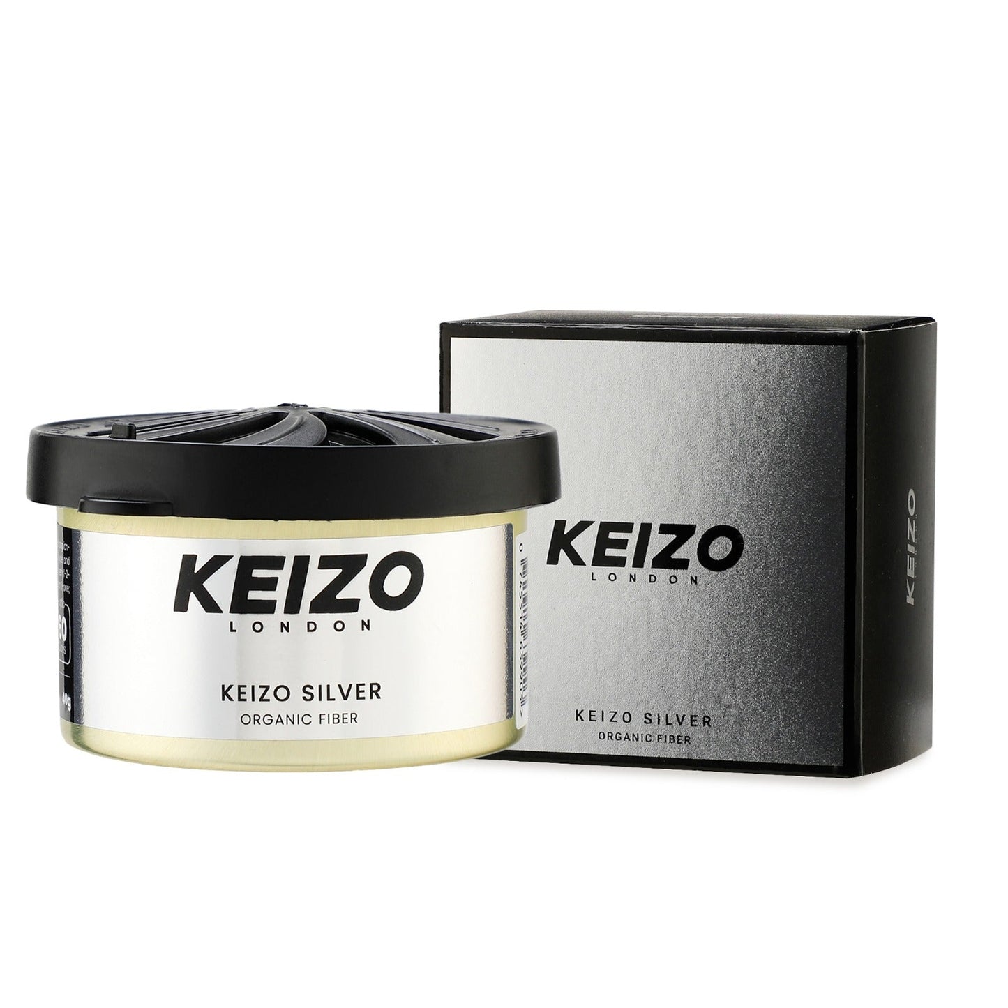 A round container of Keizo London Silver 40g Car Perfume is placed beside its matching silver and black box, both from Keizo, evoking modern luxury on a white background.
