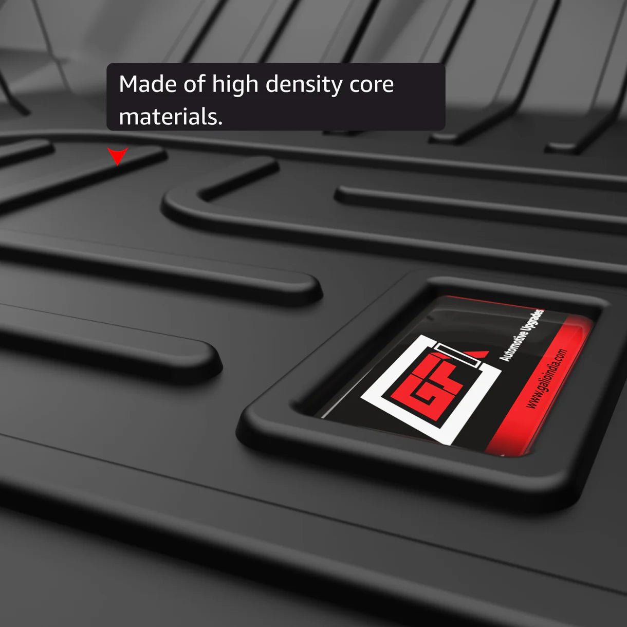 Close-up of a black textured GFX floor mat with a recessed logo and raised grooves. Text overlay: Made from high density core for precision-fit SUV mats—GFX Life Long Car Floor Mat (6 Seater) & Trunk Mat for Mahindra XUV700.