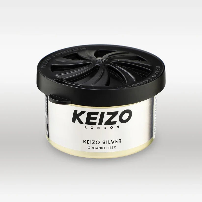 The Keizo London Silver 40g Car Perfume, featuring a sleek round container with a black swirled lid, adds modern freshness to your driving experience. The product is displayed against a plain white background.