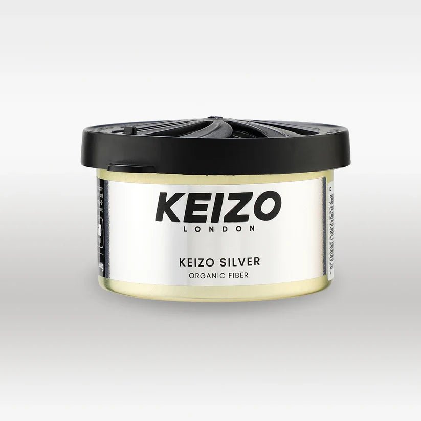 A round container of Keizo London Silver 40g Car Perfume by Keizo, with a black lid and white label, is displayed against a light gray background, evoking modern freshness for an elegant driving experience.
