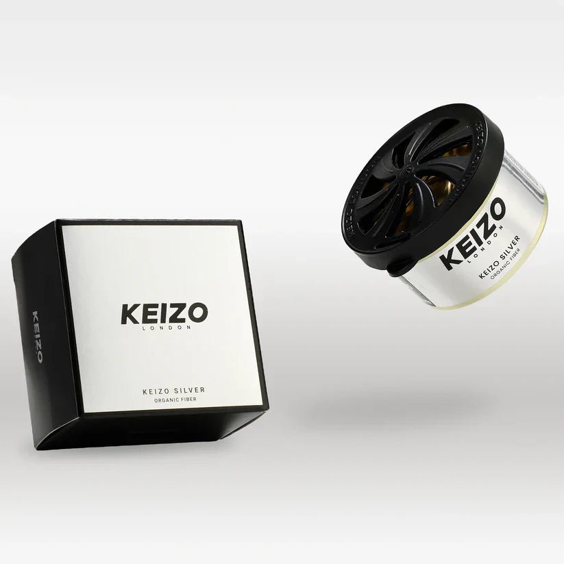 Keizo London Silver 40g Car Perfume by Keizo features a black and white box and a round silver container with a black vented lid, both labeled Keizo Silver Organic Fiber for modern freshness and an elegant drive.
